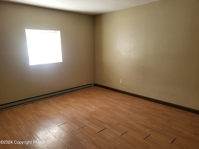 2153 Gravel Rd, Canadensis, PA 18325 - spare room with a baseboard radiator, baseboards, and wood finished floors
