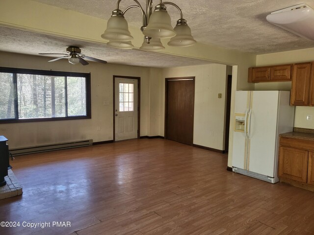 2153 Gravel Rd, Canadensis, PA 18325 - unfurnished living room with a textured ceiling, dark wood-type flooring, baseboard heating, and baseboards