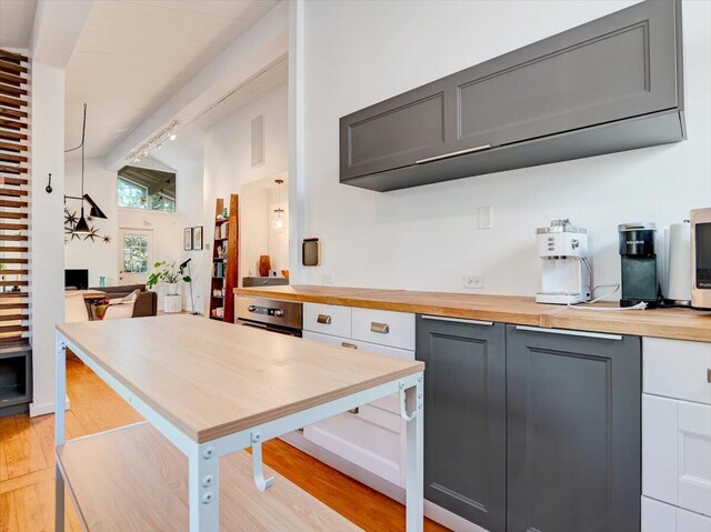 1109 Cedar Knoll Way, Pocono Pines, PA 18350 - kitchen with butcher block counters, lofted ceiling, light wood-style floors, a desk, and track lighting