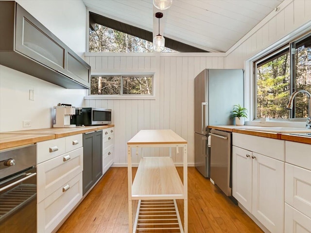 1109 Cedar Knoll Way, Pocono Pines, PA 18350 - kitchen with stainless steel appliances, butcher block counters, lofted ceiling, light wood-style floors, and healthy amount of natural light
