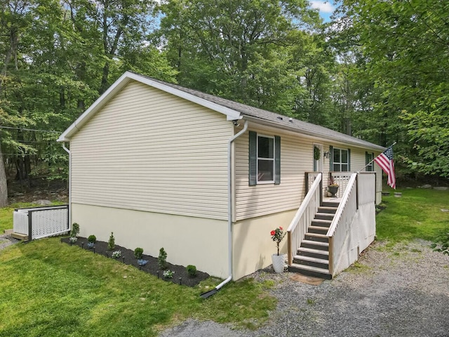 2236 Eagle Path, Bushkill, PA 18324 - view of side of home featuring a yard, view of wooded area, and stairs