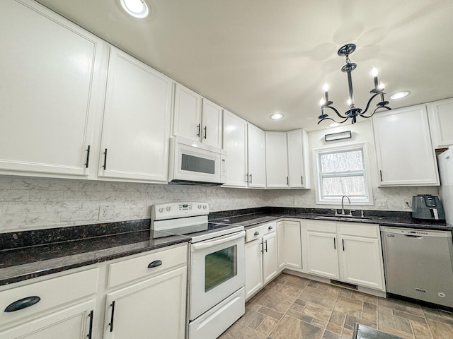 2236 Eagle Path, Bushkill, PA 18324 - kitchen with white appliances, a chandelier, white cabinets, tasteful backsplash, and recessed lighting