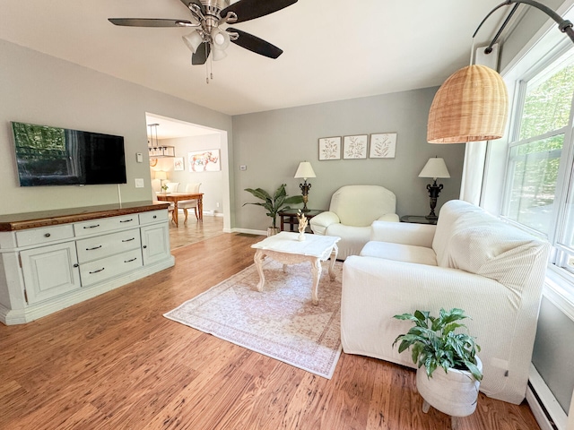 2236 Eagle Path, Bushkill, PA 18324 - living area featuring light wood-type flooring, ceiling fan, baseboard heating, and a chandelier