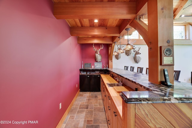 909 Interchange Rd, Kresgeville, PA 18333 - indoor wet bar featuring stone finish floors, a wooden ceiling with exposed beams, and pendant lighting