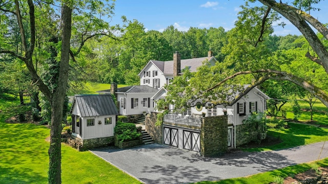 282 Crabapple Ln, East Stroudsburg, PA 18302 - view of front of house with stairway, a chimney, asphalt driveway, a front yard, and an attached garage
