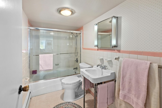 282 Crabapple Ln, East Stroudsburg, PA 18302 - full bath with tile walls, shower / bath combination with glass door, a wainscoted wall, and baseboard heating