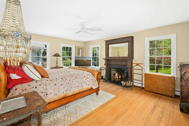 282 Crabapple Ln, East Stroudsburg, PA 18302 - bedroom featuring wood-type flooring, a lit fireplace, and baseboard heating