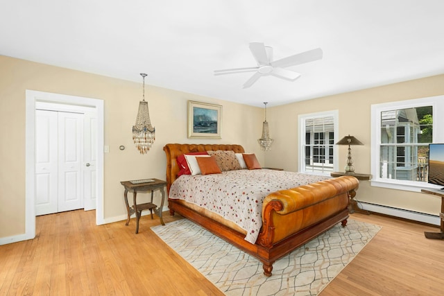 282 Crabapple Ln, East Stroudsburg, PA 18302 - bedroom with a baseboard heating unit, light wood-style floors, and a chandelier