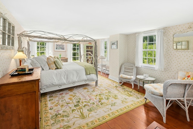 282 Crabapple Ln, East Stroudsburg, PA 18302 - bedroom featuring wallpapered walls, wood finished floors, and a baseboard heating unit