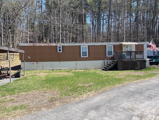 2142 Wigwam Park Rd, Stroudsburg, PA 18360 - manufactured / mobile home with a wooden deck, stairs, and a front lawn