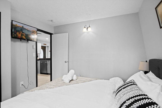 1150 Country Place Dr, Tobyhanna, PA 18466 - bedroom featuring wood finished floors, ensuite bath, and a textured ceiling