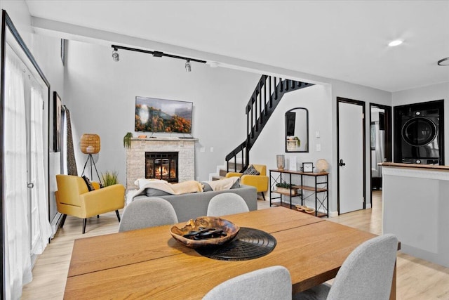 1150 Country Place Dr, Tobyhanna, PA 18466 - dining room with a brick fireplace, light wood finished floors, recessed lighting, stairway, and stacked washer and dryer