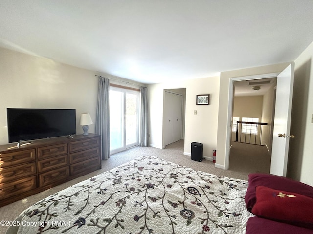 bedroom with baseboards, carpet floors, and access to exterior