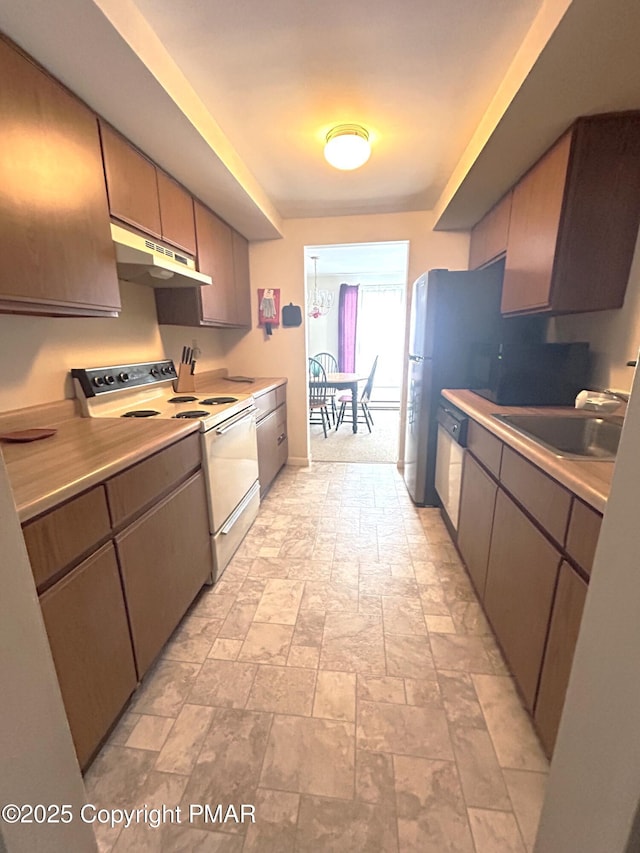 kitchen with white electric stove, sink, and stainless steel dishwasher