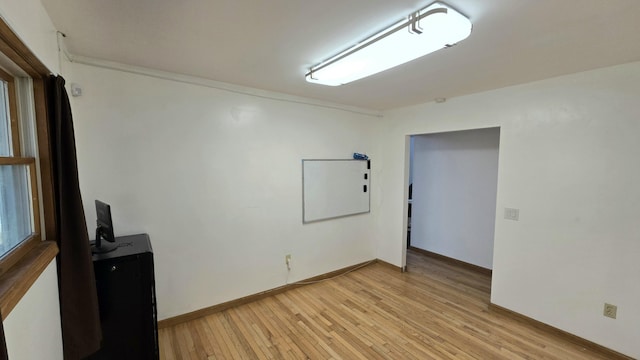 unfurnished room featuring light wood-style flooring and baseboards