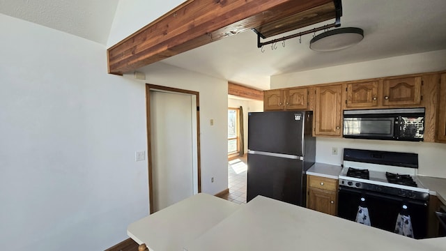 kitchen with black appliances, brown cabinetry, and light countertops