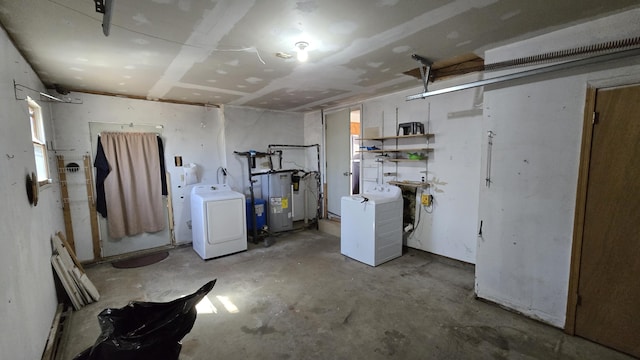 below grade area featuring separate washer and dryer and water heater