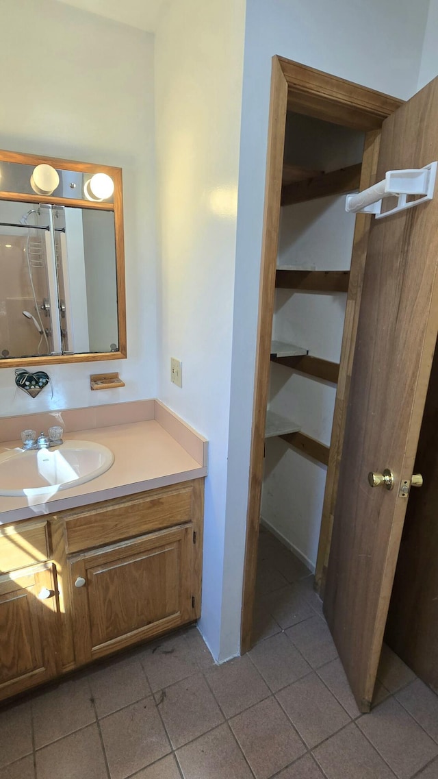 bathroom with tile patterned floors and vanity