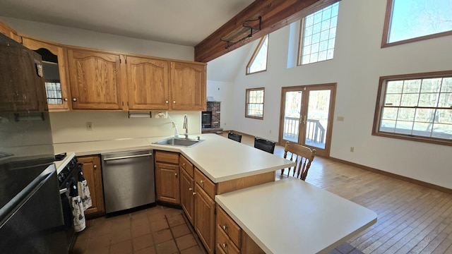 kitchen with dishwasher, light countertops, a peninsula, french doors, and a sink