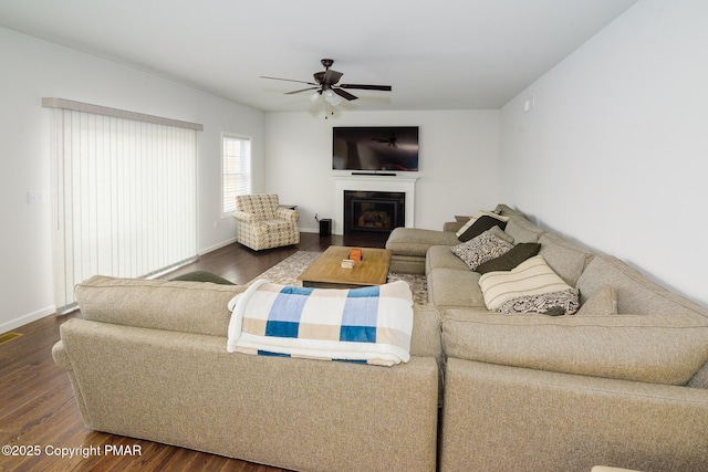 living room with dark hardwood / wood-style flooring and ceiling fan