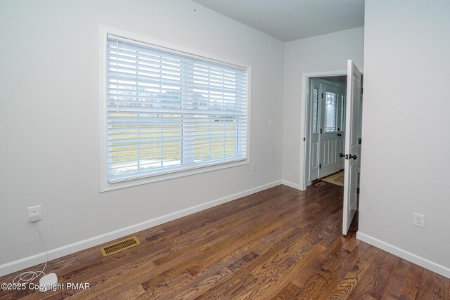 spare room featuring dark hardwood / wood-style floors