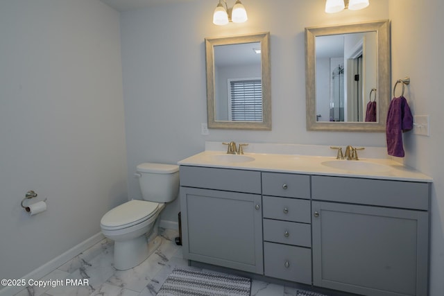 full bathroom featuring toilet, baseboards, marble finish floor, and a sink