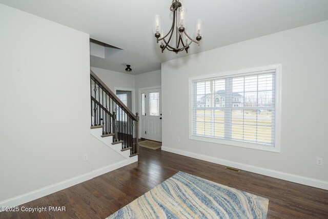 interior space with dark hardwood / wood-style floors and a chandelier