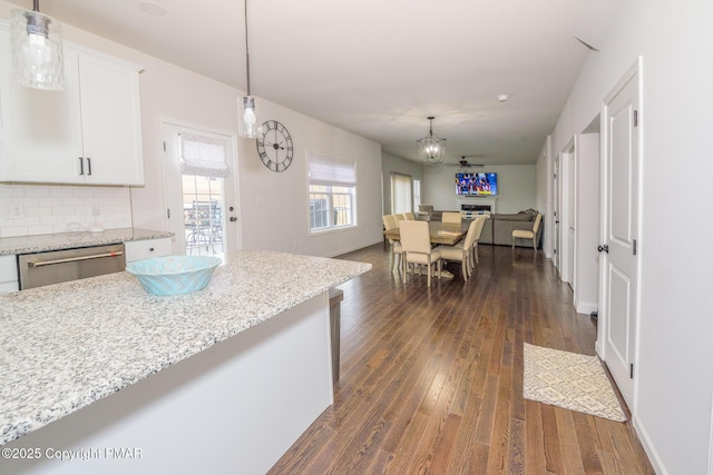 kitchen with white cabinetry, dark wood finished floors, open floor plan, dishwasher, and tasteful backsplash