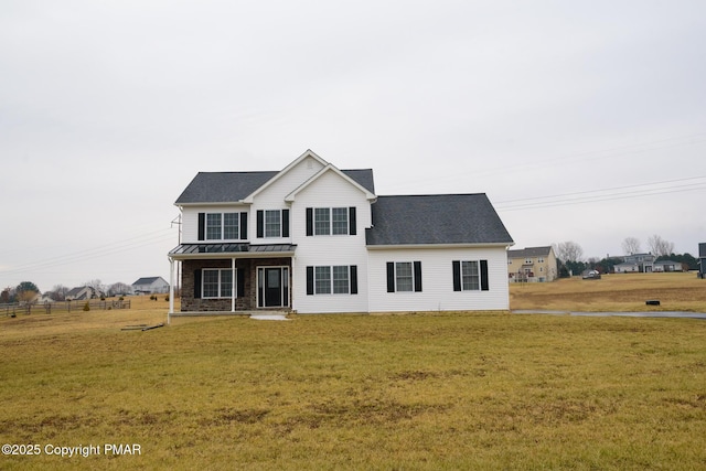 front facade featuring covered porch and a front yard