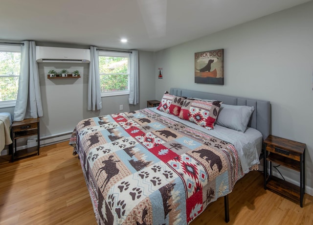 115 Squaw Trl, Pocono Lake, PA 18347 - bedroom with a baseboard radiator, light wood-style floors, a wall mounted AC, multiple windows, and recessed lighting