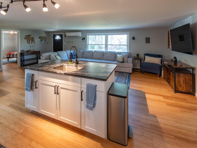 115 Squaw Trl, Pocono Lake, PA 18347 - kitchen with open floor plan, a wall unit AC, and light wood-type flooring