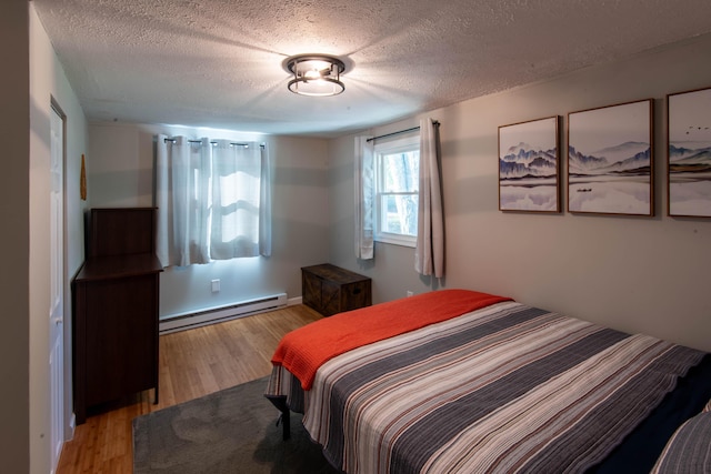 115 Squaw Trl, Pocono Lake, PA 18347 - bedroom featuring a baseboard heating unit, wood finished floors, and a textured ceiling