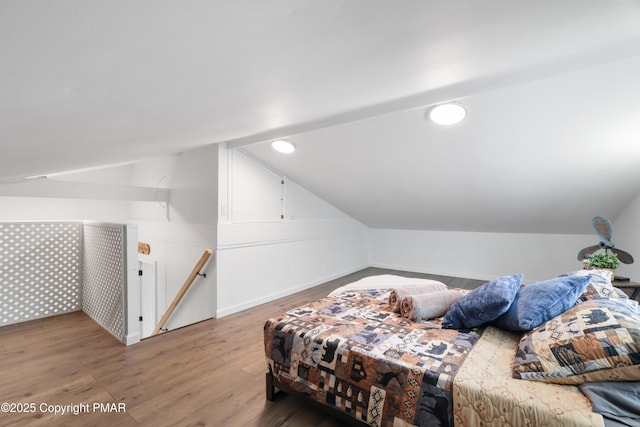 bedroom with lofted ceiling and hardwood / wood-style floors