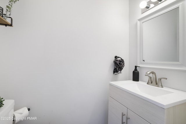 bathroom featuring toilet and vanity