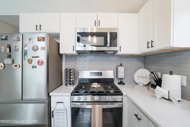 kitchen featuring appliances with stainless steel finishes, white cabinetry, and backsplash