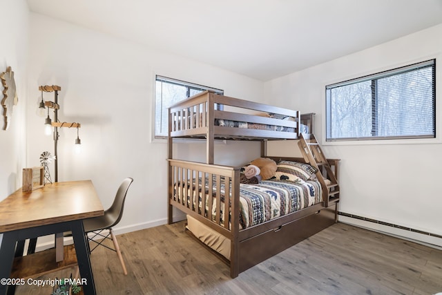 bedroom featuring a baseboard radiator and hardwood / wood-style floors