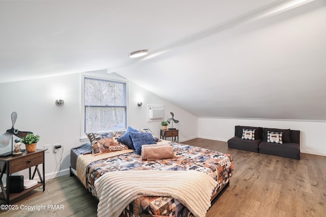 bedroom featuring vaulted ceiling and wood-type flooring