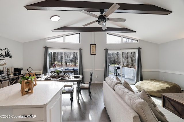 interior space featuring hardwood / wood-style flooring, vaulted ceiling with beams, and ceiling fan