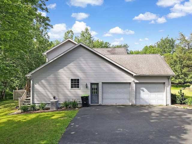1319 Poulos Ct, Stroudsburg, PA 18360 - view of side of property with an attached garage, asphalt driveway, a yard, and a shingled roof