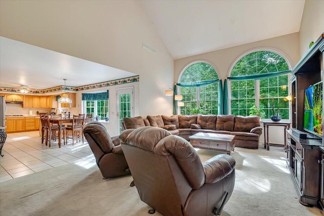 1319 Poulos Ct, Stroudsburg, PA 18360 - living area with light carpet, high vaulted ceiling, and light tile patterned floors