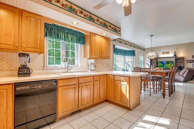 1319 Poulos Ct, Stroudsburg, PA 18360 - kitchen featuring black dishwasher, backsplash, light countertops, open floor plan, and a peninsula