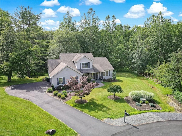 1319 Poulos Ct, Stroudsburg, PA 18360 - view of front of house with a front yard, covered porch, a view of trees, and driveway