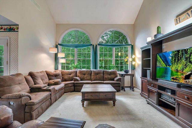 1319 Poulos Ct, Stroudsburg, PA 18360 - living area featuring light colored carpet, healthy amount of natural light, and high vaulted ceiling