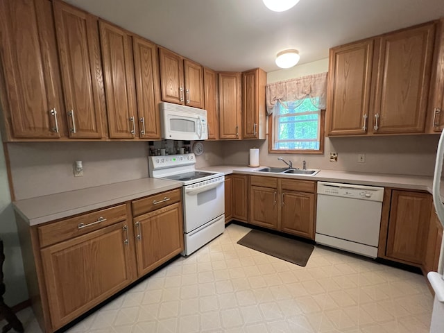2291 Mountain Rd, Stroudsburg, PA 18360 - kitchen with white appliances, a sink, brown cabinets, light flooring, and light countertops