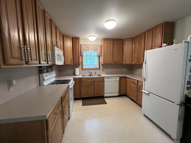 2291 Mountain Rd, Stroudsburg, PA 18360 - kitchen featuring white appliances, a sink, light flooring, brown cabinets, and light countertops