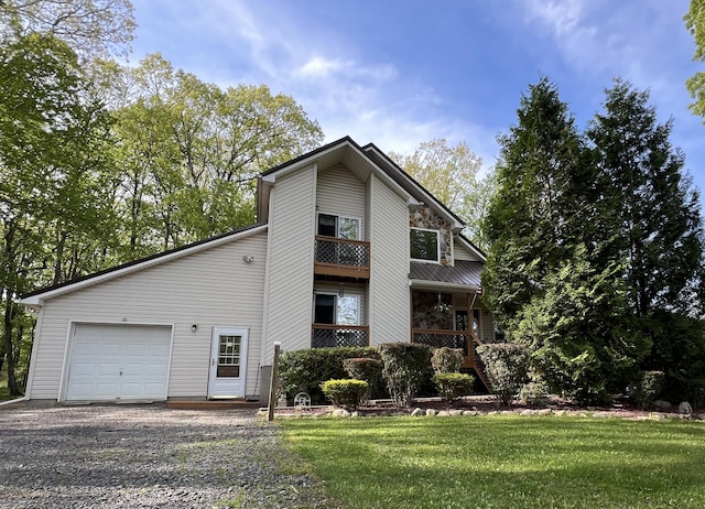 2291 Mountain Rd, Stroudsburg, PA 18360 - view of front of house with a garage, gravel driveway, a front lawn, and a porch