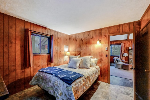 bedroom featuring wood walls