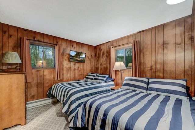 bedroom featuring a baseboard heating unit and carpet