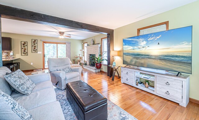 1154 Park Dr, East Stroudsburg, PA 18302 - living room with light wood-type flooring, beam ceiling, a ceiling fan, and a fireplace