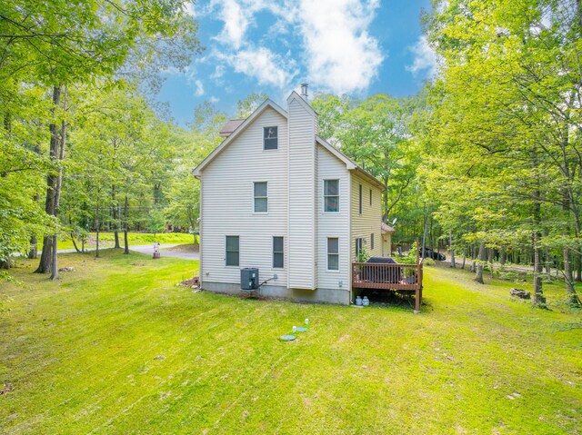 1154 Park Dr, East Stroudsburg, PA 18302 - back of property with a chimney, a yard, a deck, and view of scattered trees